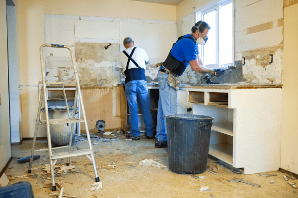 two men tearing out kitchen during home renovations