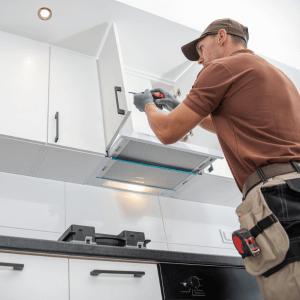 Contractor Worker Assembling of New Kitchen Cabinets for home renovation